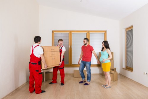 Movers carrying furniture through a Mayfair property with careful access planning